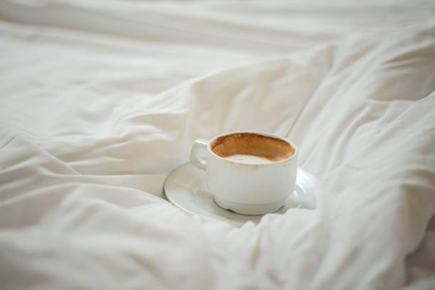 istock a cup of coffee on a rumpled bed, morning coffee in bed 1560988571