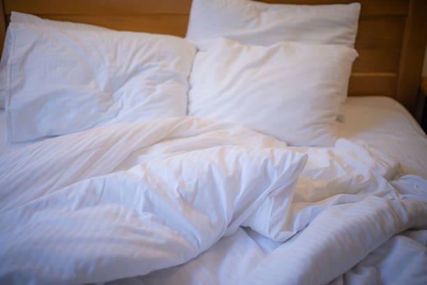 istock unmade bed after sleep, wrinkled bed linen 1560988589