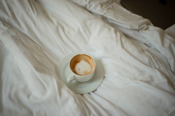 istock a cup of coffee on a rumpled bed, morning coffee in bed 1560989109