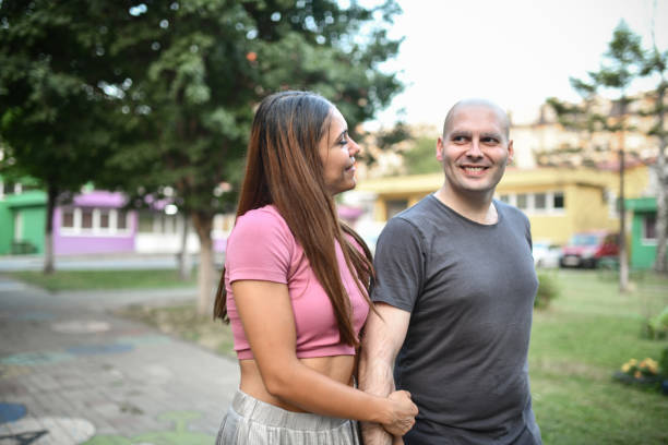 istock Supportive Female Taking A Walk With Balding Husband After Defeating Cancer With Chemotherapy 1560999775