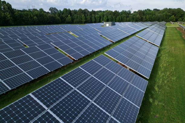 istock Solar panels on a field of green grass 1561019282