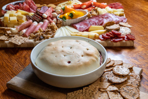 istock Bountiful charcuterie board showcases an array of cheeses, meats, and a sumptuous baked brie, a delightful gourmet experience. 1561031824