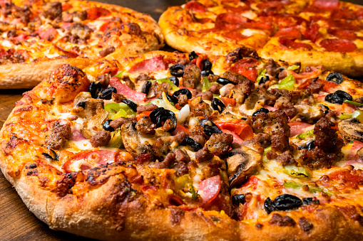 Mouthwatering oven-baked pizzas: adorned with assorted meats, pepperoni and cheese, and a supreme selection of savory toppings.