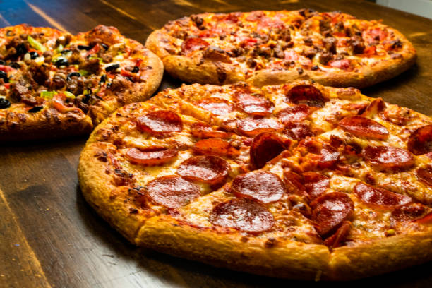 istock Savory oven-baked pizzas: loaded with assorted meats, classic pepperoni and cheese, and a supreme medley of toppings. 1561032662