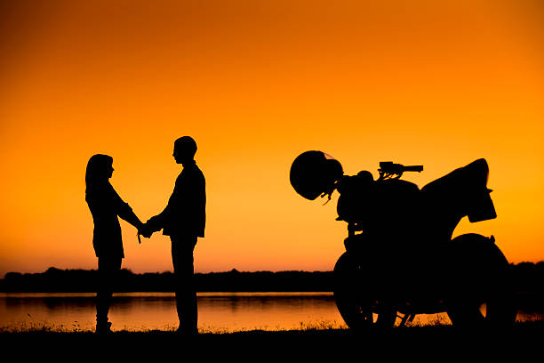 young couple at sunset stock photo