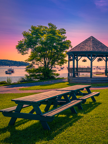 Pavillion and outdoor table with bench on the Green of Steamboat Landing Park in Belfast along the Passagassawakeag River in Waldo County, Maine.