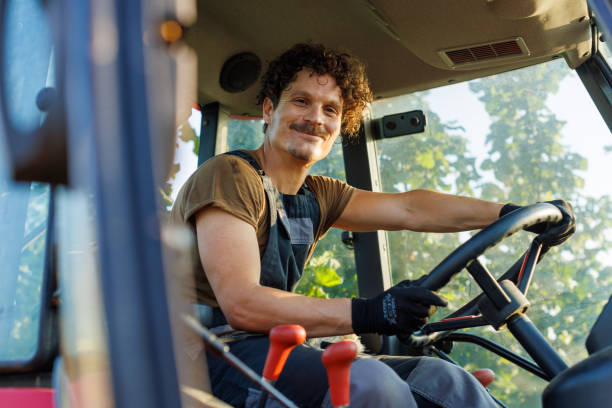 istock A Farmer Drives A Tractor On A Farm 1561071738