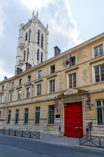 Paris, France - July 21, 2023: Facade of Lycée Henri IV, a public secondary and higher education institution located in the Latin Quarter, with the Clovis tower in the background