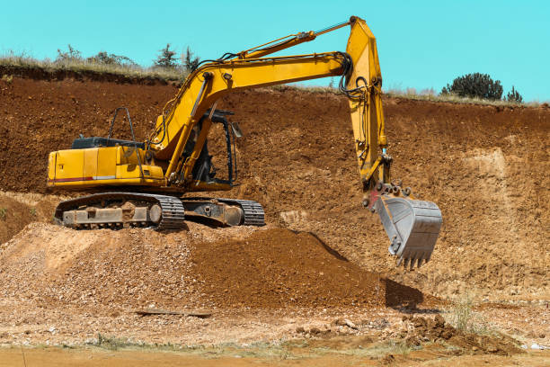 istock Enormous Excavator Parked On Dirt Mound While Digging Out More 1561105083
