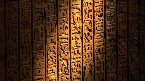 Light spot moving on ancient egypt hieroglyphics carving on wall of temple