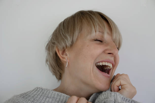 istock Smiling happy woman portrait on light background 1561108355