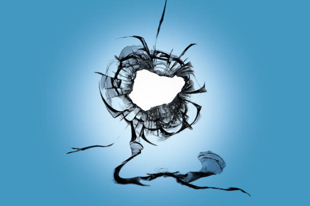 istock A hole with cracks on the window glass. Consequences of shelling. Hole from damage by weapons. 1561126428