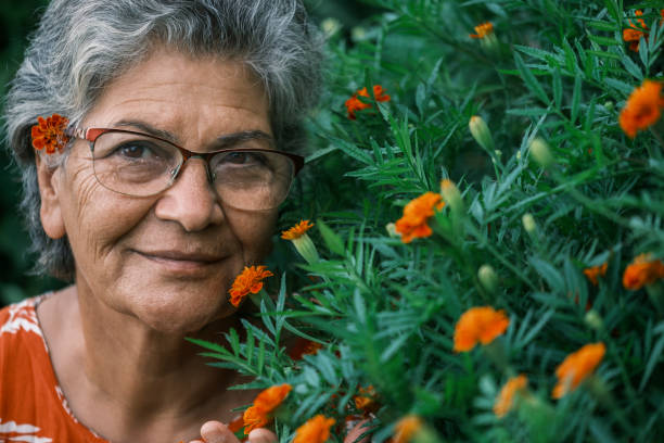 istock Old middle eastern woman smiling with her flowers 1561169348