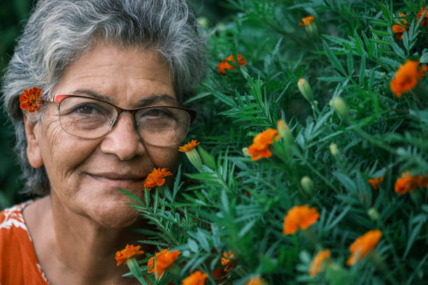 istock Old middle eastern woman smiling with her flowers 1561170395