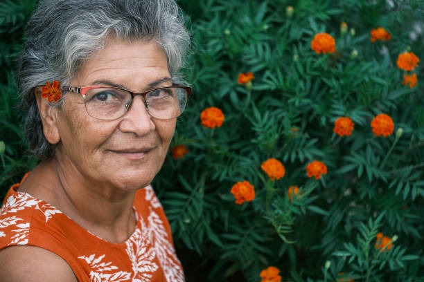 istock Old middle eastern woman smiling with her flowers 1561170906
