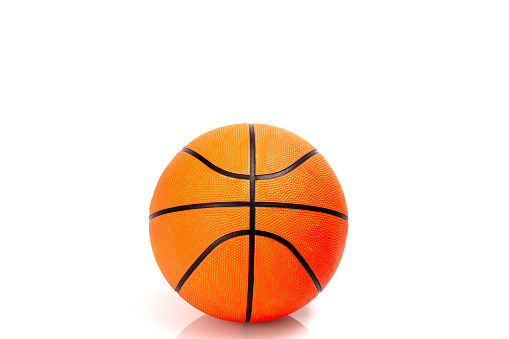 Old deflated basketball isolated on white background