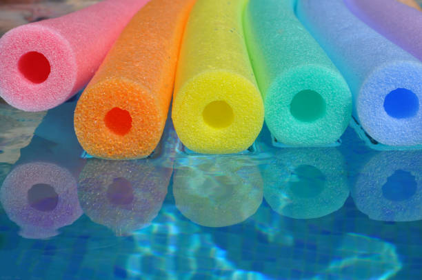 colorful pool noodles as background of rainbow colors