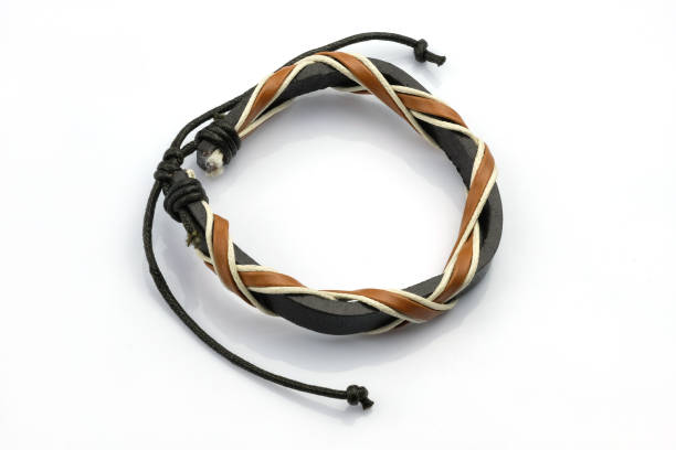 istock Black and brown leather bracelet on a hand on a white background. 1561202412