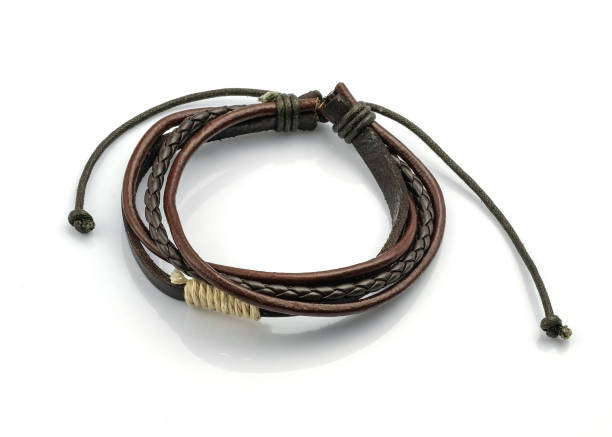 istock Brown leather bracelet on a hand on a white background. 1561202413