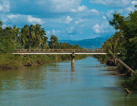 Locally known as Lugway Bridge, this one was built at early 90's. I personally witnessed how it was built from the ground up as a kid. I used to swim and play in this river when I was little. I grew up in a house beside that leaning coconut on the right. Taken at Ilog, Negros Occidental, Philippines.