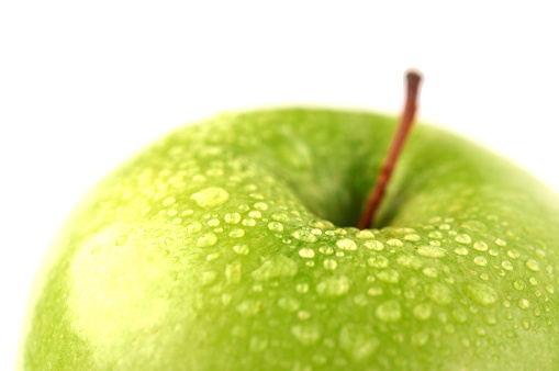 Macro of red apple.Wet ripe apple covered with water drops.