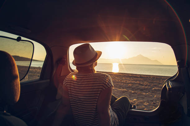 istock Pregnant woman watching the sunset on a beach 1561267995
