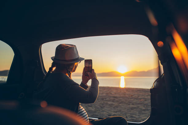 istock Pregnant woman watching the sunset on a beach 1561269029