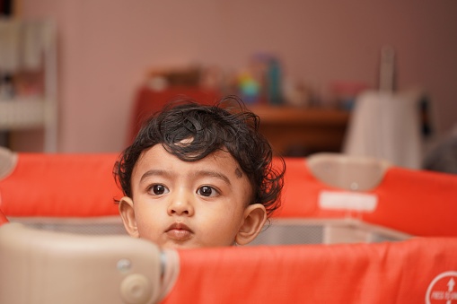 A one-year-old boy is depicted in a dejected state, conveying the concept of child psychology and depression