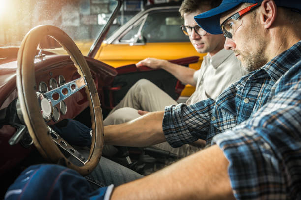 istock Professional Classic Cars Mechanic Checking on His Client Vehicle 1561319781
