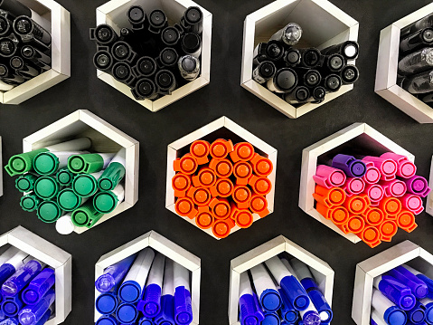 Organized pens markers in shelves in a retail store