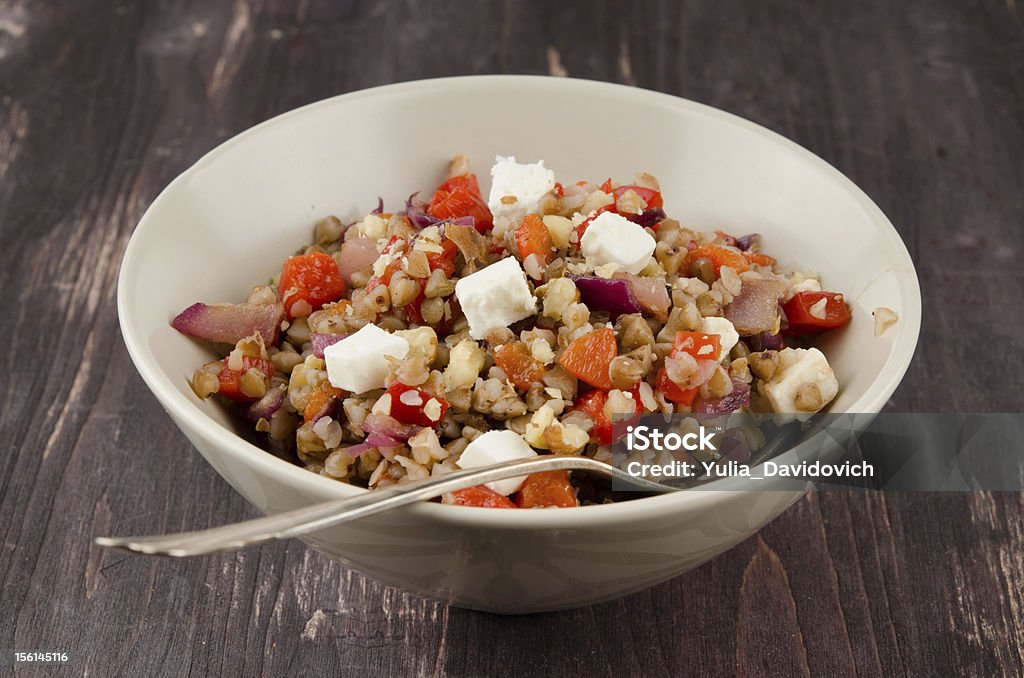 buckwheat salad with roasted peppers and feta Buckwheat salad with roasted peppers and feta in a ceramic bowl, close-up Buckwheat Stock Photo