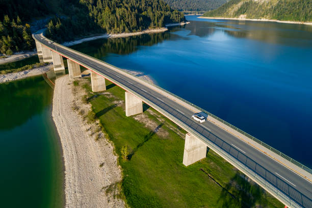 istock Bridge on mountain lake, aerial view 1561475990
