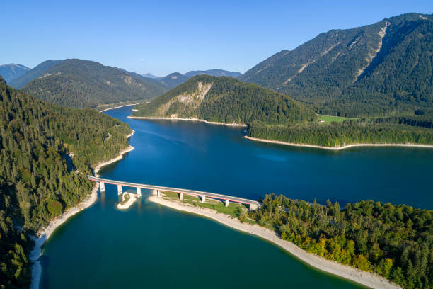 istock Mountain lake with bridge, aerial view 1561483243