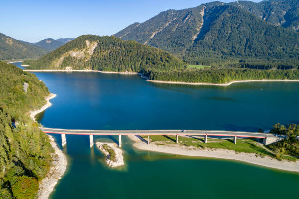 istock Mountain lake with bridge, aerial view 1561489794