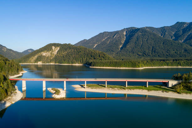 istock Mountain lake with bridge, aerial view 1561496092