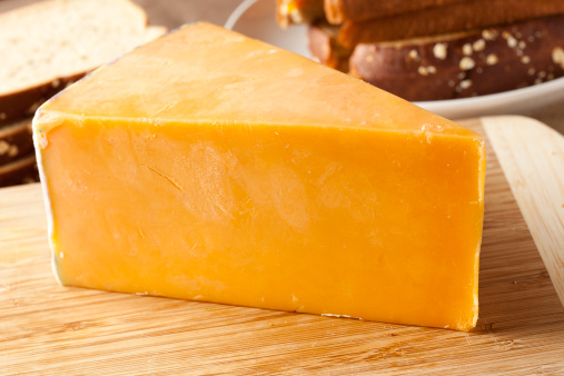 Traditional Yellow Cheddar Cheese on a background
