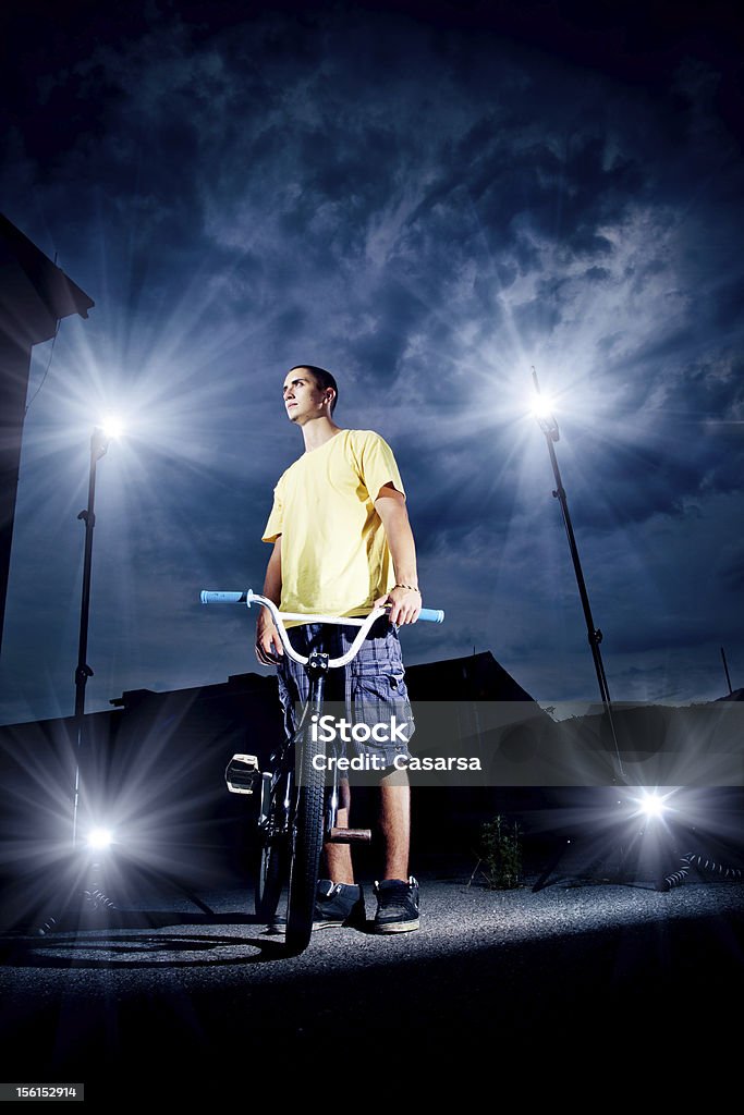 BMX rider Portrait of a teenager with his BMX bike. Night Stock Photo