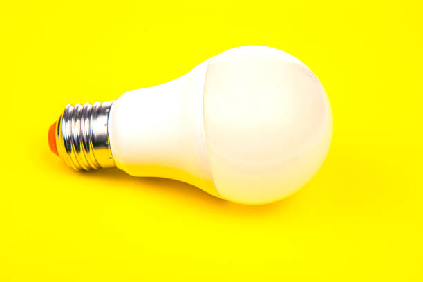 istock white led lamp on yellow background 1561572720