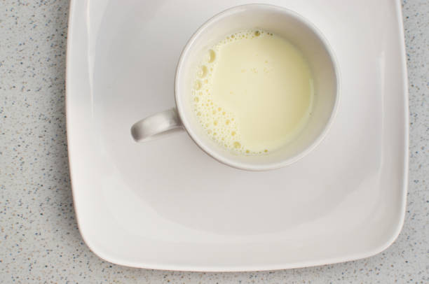 istock A white cup of fresh, creamy milk, ready to enjoy at a lighted table. 1561577438