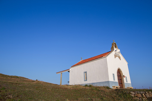 White church building landmark. Catholic religion architecture hermitage with sky for copy space background
