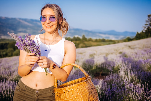 Beautiful woman in lavender field in sunset