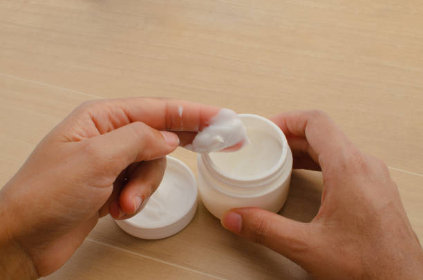 istock Featured hydration: hands using nourishing cream to make skin soft and hydrated. 1561655559
