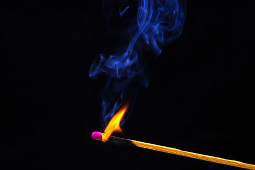 Set of burning matches on a dark background