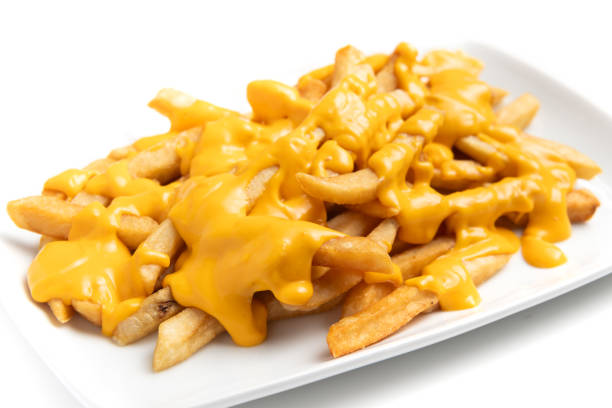 French fries loaded with melted cheddar cheese on white background