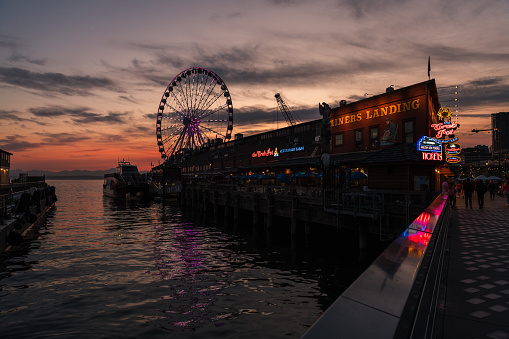 Seattle, USA - Jun 23, 2023: Sunset over Elliott Bay on the waterfront with the Seattle Great Wheel.