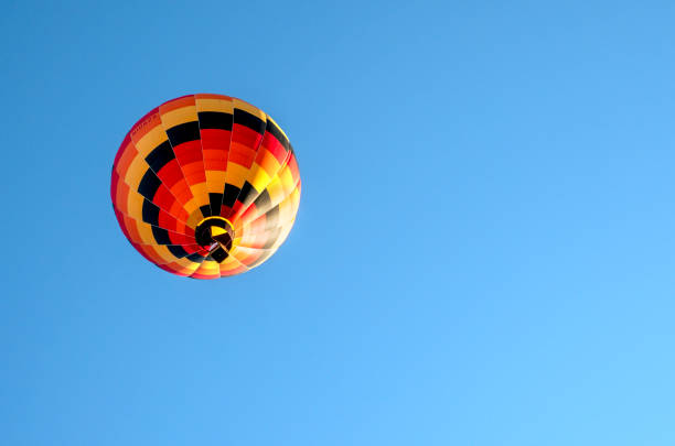 istock Colorful hot air balloon against blue sky. Space for text 1561801052