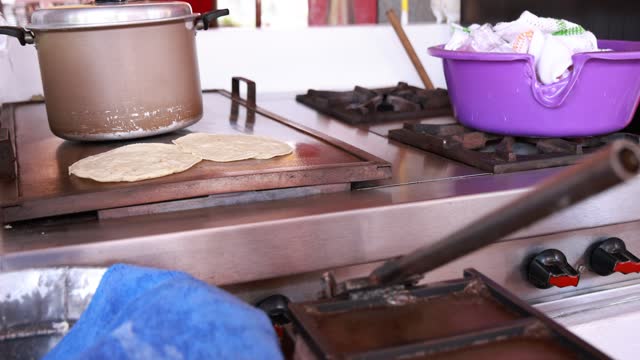 Handmade tortillas on the comal heating up