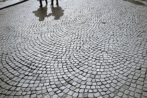 Shadows of people walking in Verona's square