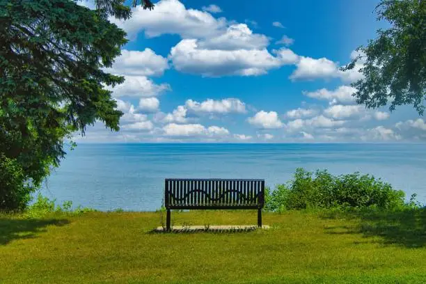 Photo of Empty Bench Facing Lake