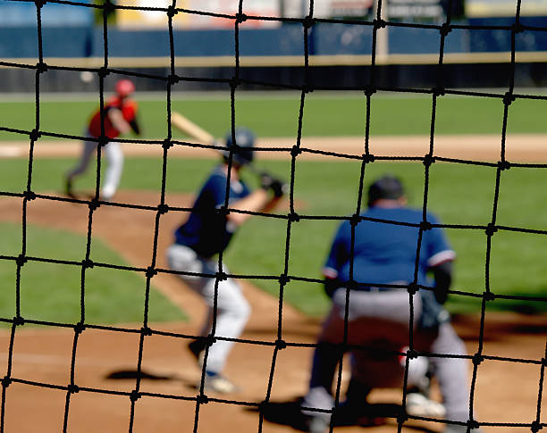 Baseball Backstop Net A baseball net protecting viewers from foul balls. home run photos stock pictures, royalty-free photos & images